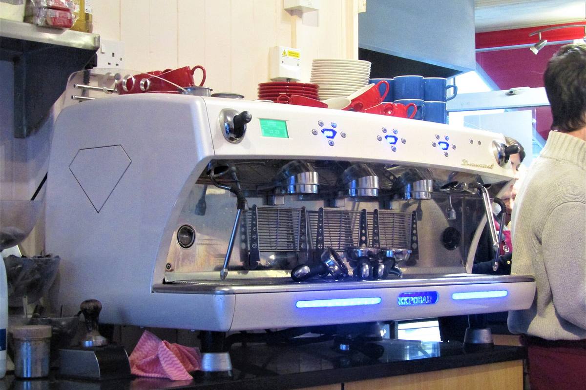 Barista preparing coffee behind a café counter