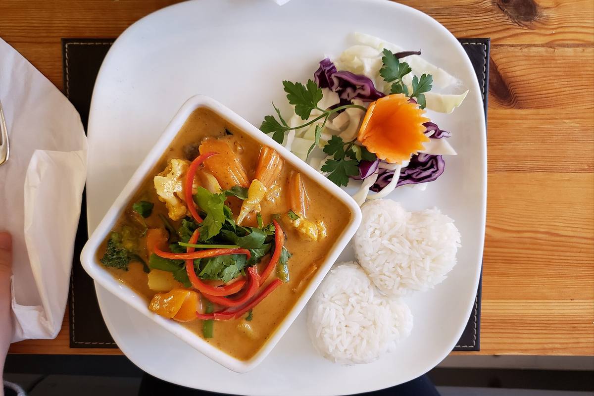 Thai curry served with rice and vegetables